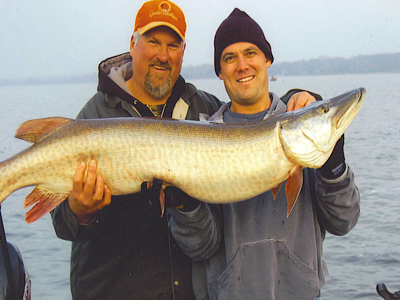 Two men holding a large muskie